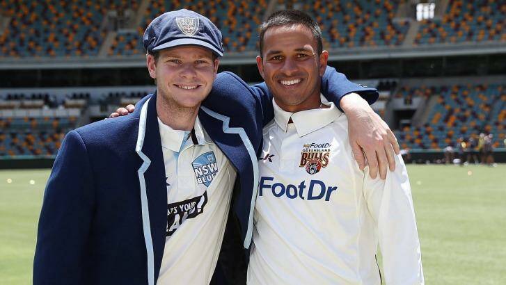 Shield action: Steve Smith and Usman Khawaja are all smiles after the coin toss at the Gabba. Photo: Chris Hyde