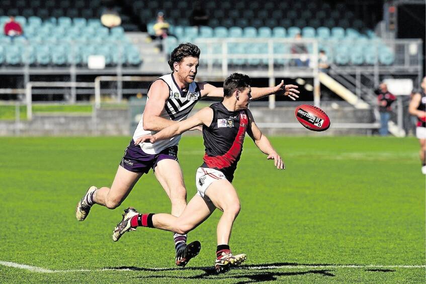 North Launceston’s Jack Avent and Burnie’s Tyrone Morrison charge after the ball in Saturday’s preliminary final at Aurora Stadium. Pictures: PAUL SCAMBLER