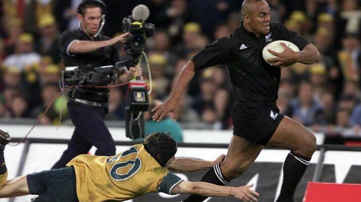 On the charge: Jonah Lomu takes on the Wallabies in front of 109,000 fans in the year 2000. Photo: Craig Golding