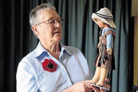 Robin Walker, of South Launceston, with the doll dressed in the Broadland House winter uniform. Picture: PAUL SCAMBLER