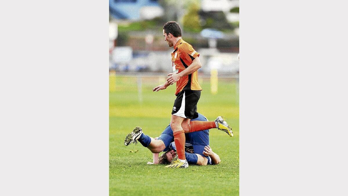 Somerset's James Nettleton takes a tumble as Riverside's Todd Mitchell runs by during an at times heated contest yesterday. Picture: SCOTT GELSTON