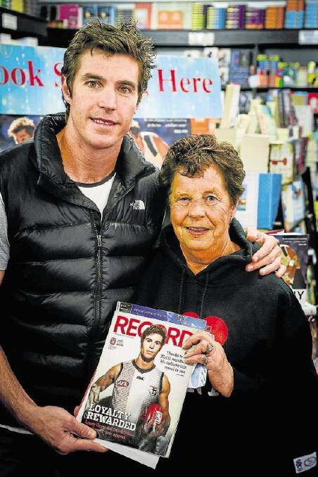 Former St Kilda AFL footballer Lenny Hayes with life-long St Kilda fan Bev Catlin of Launceston at Petrarch's Bookshop yesterday. Picture: Phillip Biggs. 