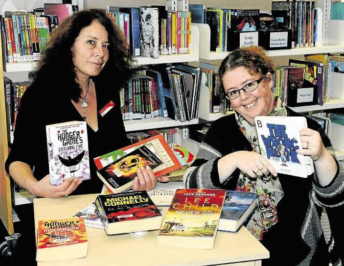 Launceston LINC staff Ruby Crowe and Kylie Mallett with Tasmania's most popular books of 2014. Picture: NEIL RICHARDSON