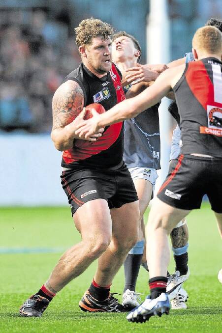 The Northern Bombers' Daniel Roozendaal marks at Aurora Stadium yesterday in the grand final win over the Western Storm.
