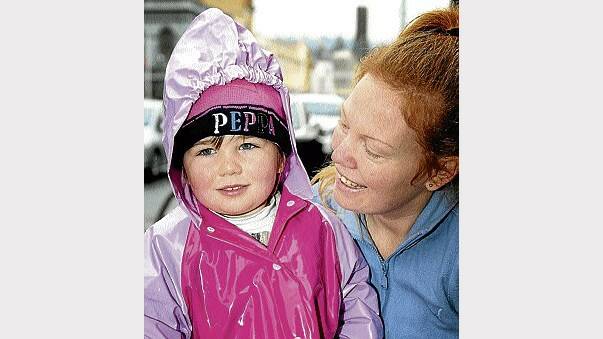 Violet Richardson, 3, and her mum Rebeka Fitzallen, of Launceston, rugged up yesterday to ward off the cold. Picture: MARK JESSER