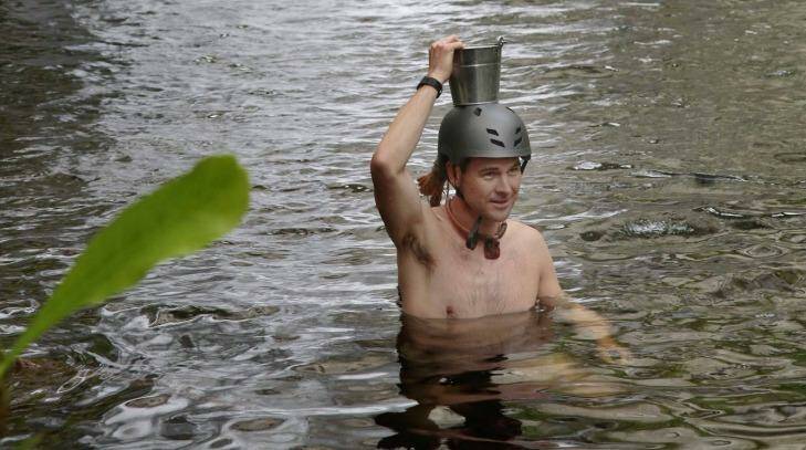 I was instructed to walk to a nearby waterfall, strip to my underpants and capture water in a metal bucket attached to my head. The reason for all this remains unclear to me. Photo: Nigel Wright/supplied by Channel Ten