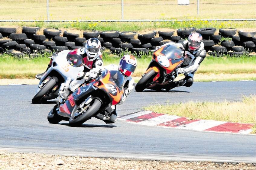 Andrew Blackberry and Mike and Will Swan in action in the 250cc Tasmanian Motor Cycle Club road racing championships. Picture: AMII McCLYMONT