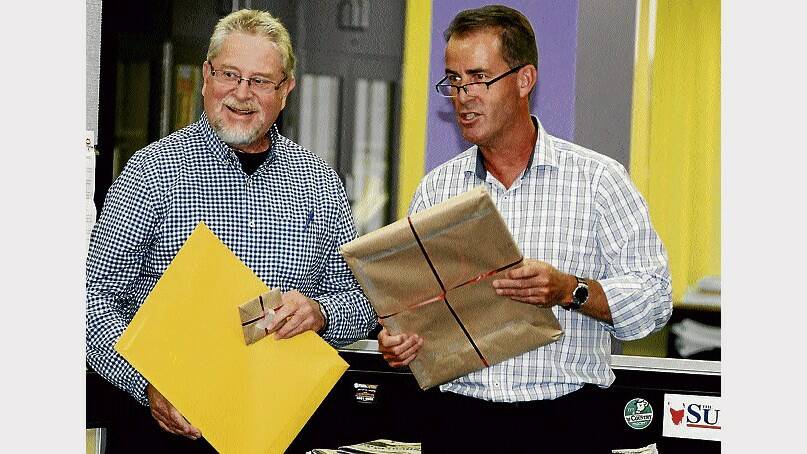 Julian Burgess (left) is congratulated by Examiner editor Martin Gilmour after completing a 45-year career with the newspaper. Picture: NEIL RICHARDSON