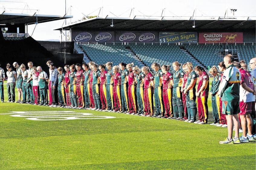 The Tasmanian Roar and Queensland Fire players pause for 63 seconds of silence in memory of Phillip Hughes at Aurora Stadium. Picture: SCOTT GELSTON. 