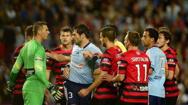 Sasa Ognenovski of Sydney FC scuffles with Wanderers players.  Photo: Brett Hemmings