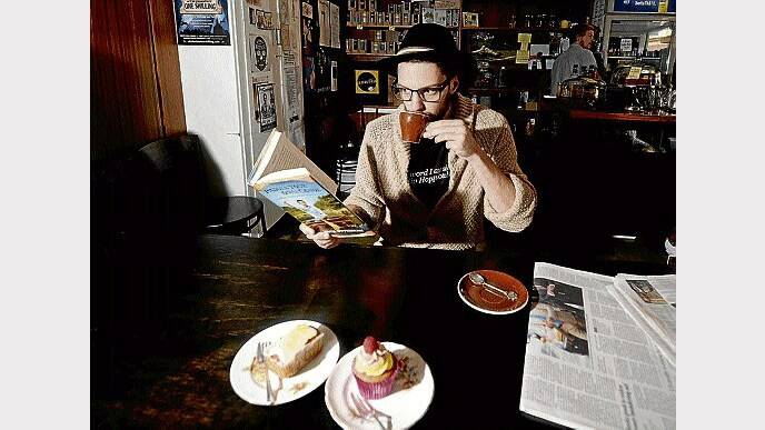 Brad Cubitt, of Launceston, enjoys a good book while enjoying his coffee at Amelia Espresso. Picture: GEOFF ROBSON