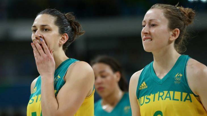 Canberra Capitals player Marianna Tolo (left) and Natalie Burton leave the court dejected after their quarter-final exit at the Olympics. Photo: Phil Walter