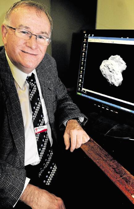 QVMAG astronomer Martin George with a picture of the comet Churyumov-Gerasimenko. Ukrainian Klim Churyumov - one of two discoverers of the comet - is a colleague of Mr George. Picture: GEOFF ROBSON
