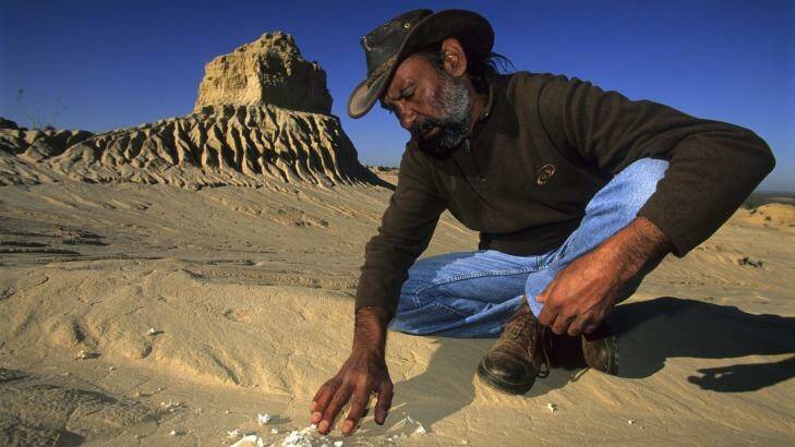 A guide points out partially buried bones in Mungo National Park. Photo: Supplied