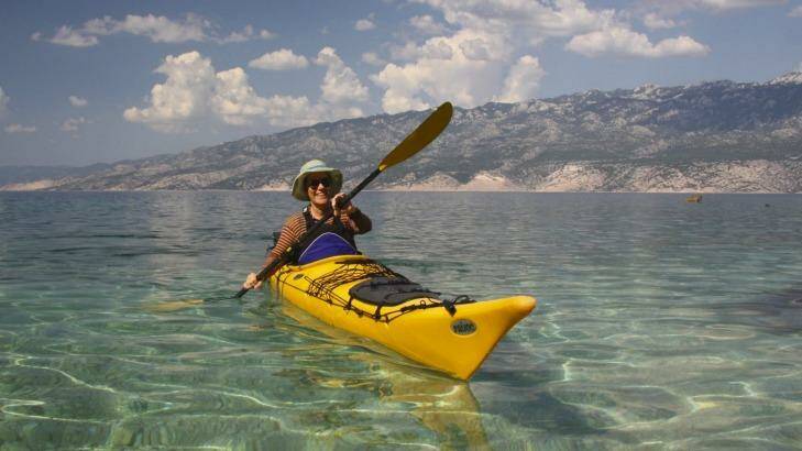 Paddling in to a beach for a swim, the Velebit mountains in the background Photo: Louise outherden 