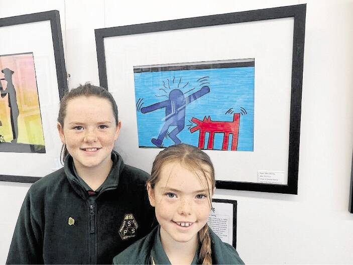 Scottsdale Primary School pupils Abbey Chorley stands in front of her artwork with her sister Paige.