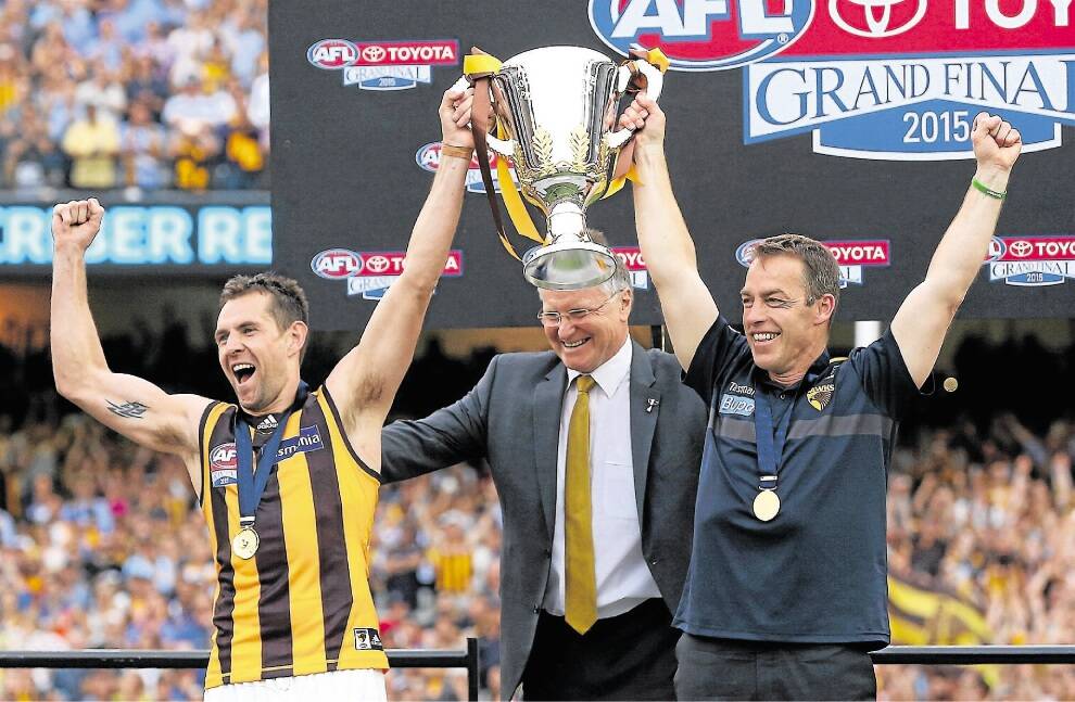 Hawthorn captain Luke Hodge and coach Alastair Clarkson hold up the premiership trophy after overcoming the West Coast Eagles.