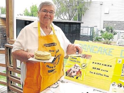 Colleen Grieve works at last year's pancake day at Longford. The event, run by the Longford Uniting Church, will raise money for the Helping Hand Association.