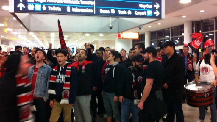 Wanderers fans welcome home their heroes at Sydney Airport on Thursday night.