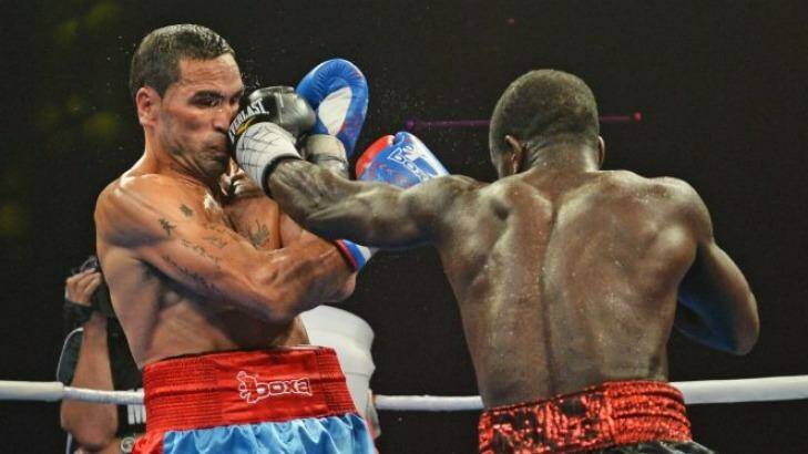 Blow by blow: Joshua Clottey (right) dishes out the punishment to Anthony Mundine. Photo: Marina Neil