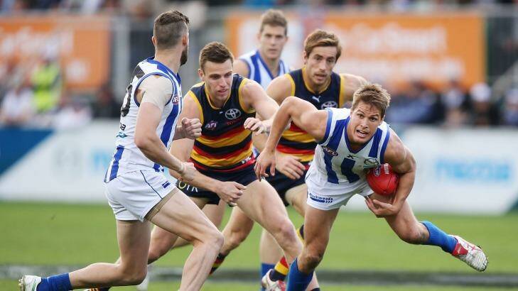 Roos' Andrew Swallow wins the ball from Brodie Smith.