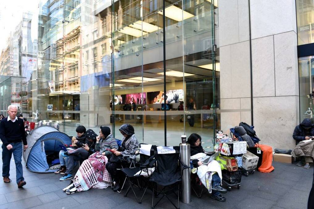 Tent city: iPhone fans (and those working as place holders) outside Apple's Sydney store in George St on Friday morning. Photo: Steven Siewert