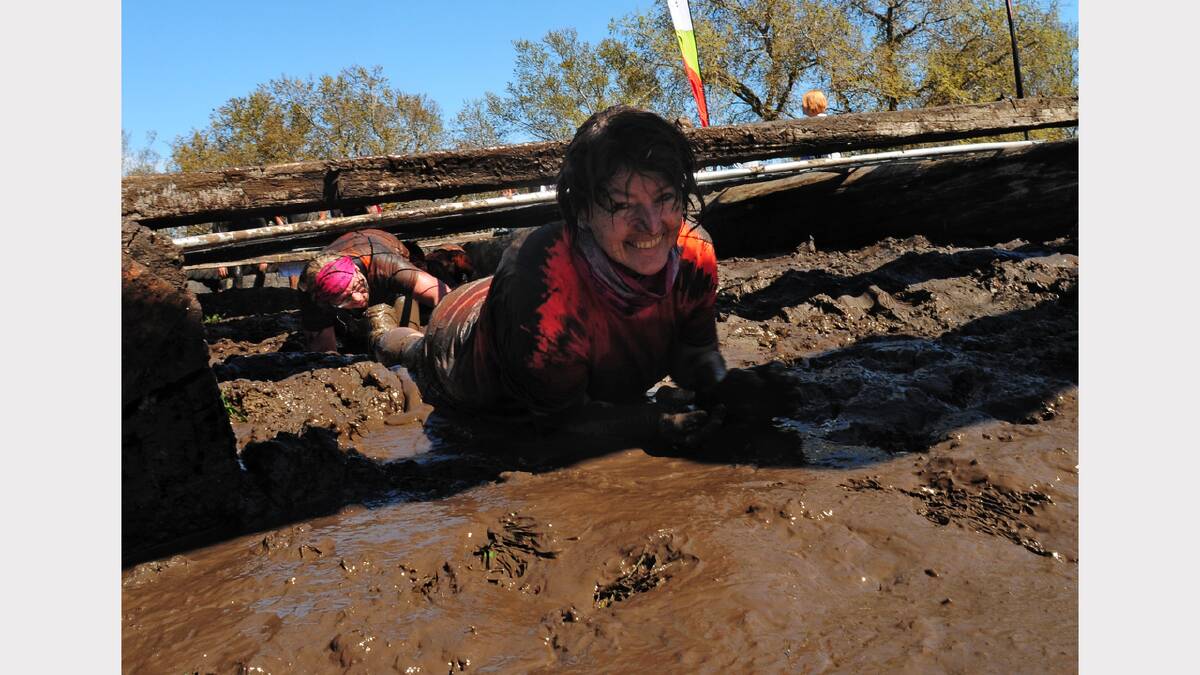 Mauren Ollington, of Riverside, can still crack a smile during the Mud Run at Evandale. Picture: Peter Sanders