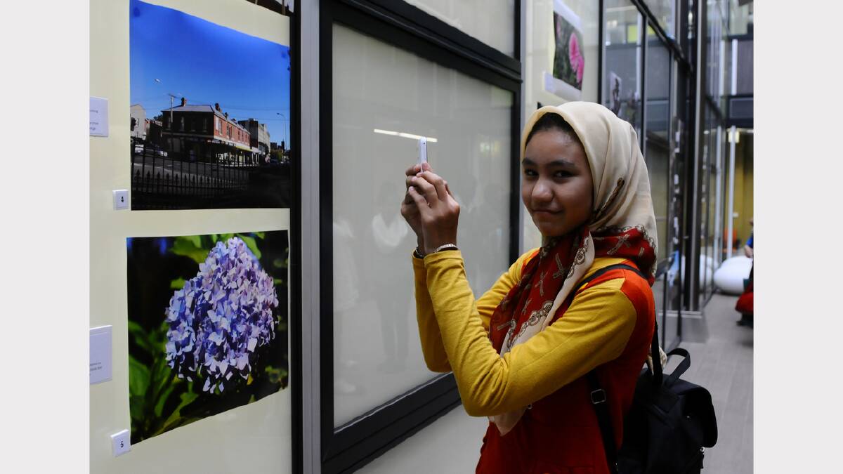 Hadis Ashouris, of Afghanistan, takes a phone photo of her competition entries. Picture: Neil Richardson