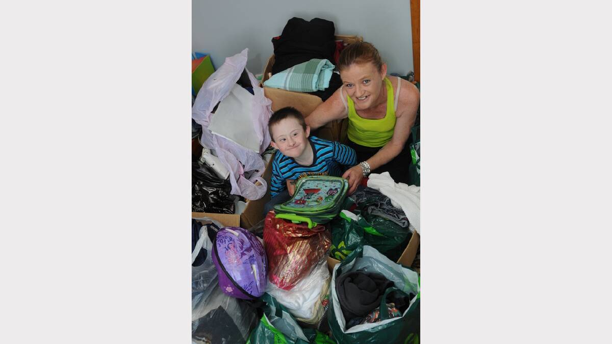 Tamieka Brooks and her son Hunta, 8, sort out goods for the garage sale fund-raiser.
Picture: PAUL SCAMBLER
