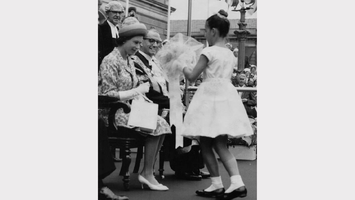 Queen Elizabeth and Prince Philip's 1963 royal visit | Patricia Cleary, 10, presents Her Majesty with a bouquet of flowers after the official welcome at the Hobart Town Hall.