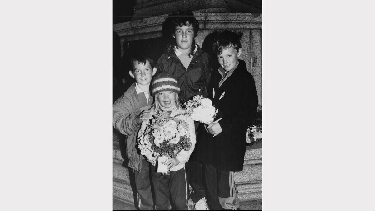 Anzac Day flashback gallery | Travis Hennessy, Natalie LeFevre, Sonya Hennessy and Nathan LeFevre with flowers at the Launceston dawn service, 1991.