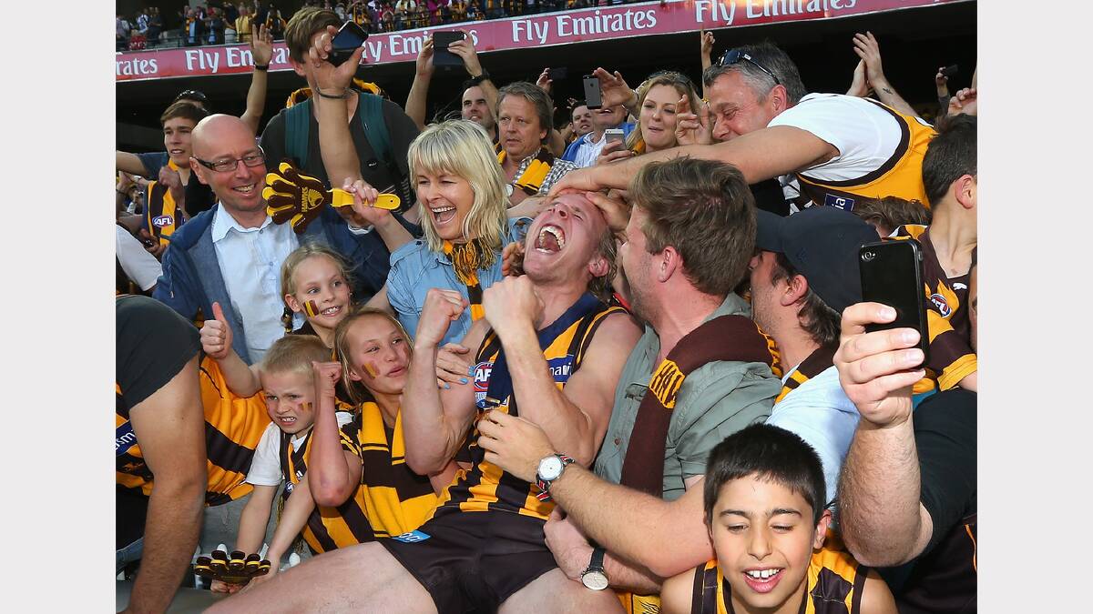 Will Langford of the hawks celebrates with fans after winning the 2014 AFL Grand Final. Picture: Getty Images
