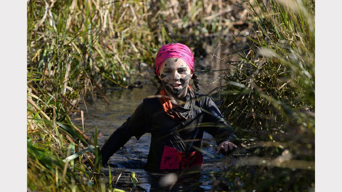 Isabel Brown, 9, wades through the course at Tas Mud Run at Evandale. Picture: Mark Jesser