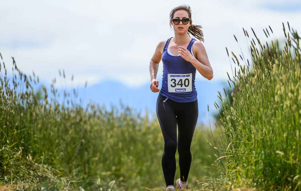 Claire Burbury digs deep amind the picturesque course. Picture: Phillip Biggs
