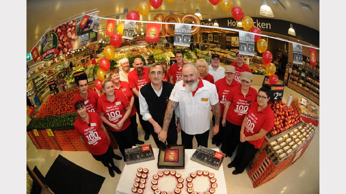 Coles Mowbray store manager Peter Grossman and Grant Perkins cut the 100th Birthday cake. Picture: Paul Scambler