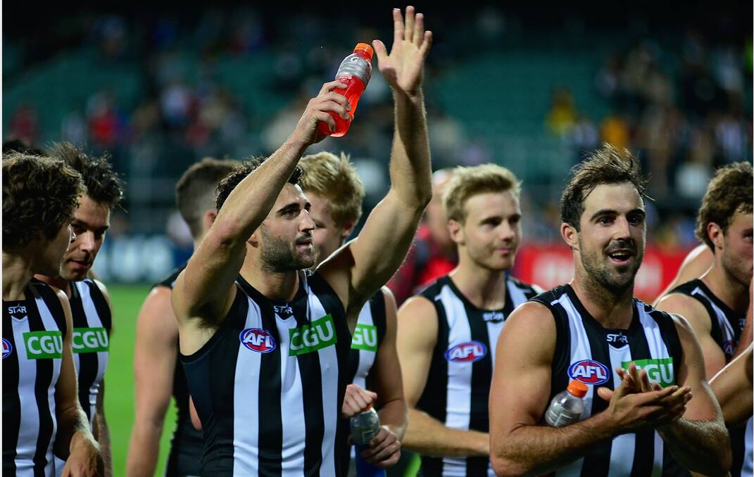 Collingwood celebrate after taking the win from Hawthorn by 44 points. Picture: Phillip Biggs
