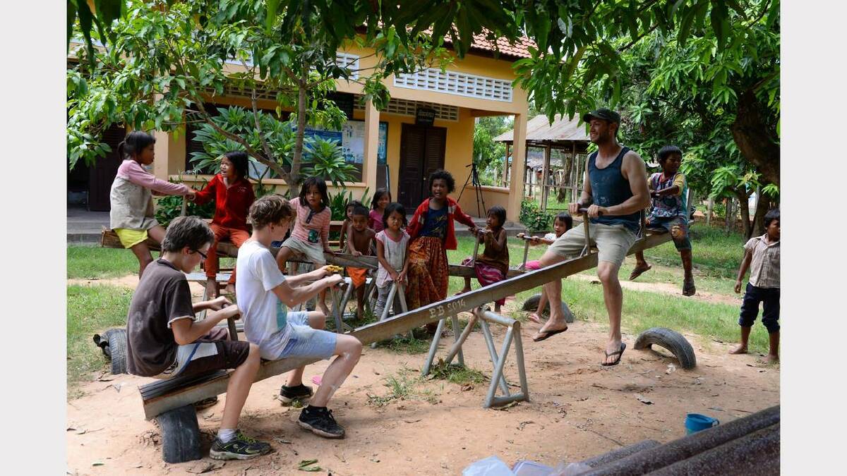Jack Norris, Elijah Harvey and St Marys District High School teacher Tom Spykers making the most of their time in Cambodia.