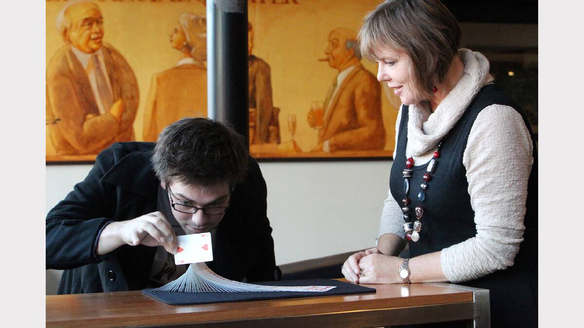 Tasmanian illusionist Bodane Hatten demonstrates his impressive card skills as The Examiner's arts writer Mary Machen looks on.  Picture: SUPPLIED