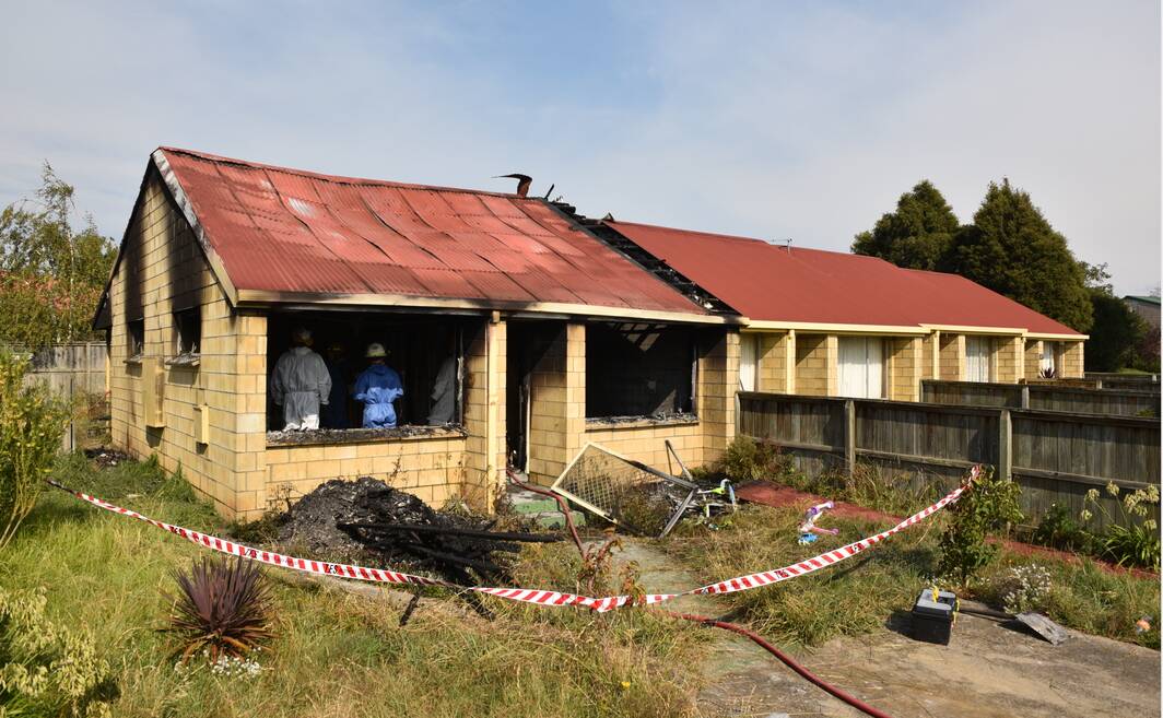 Investigators on the scene of a house fire at Mowbray. Picture: Paul Scambler
