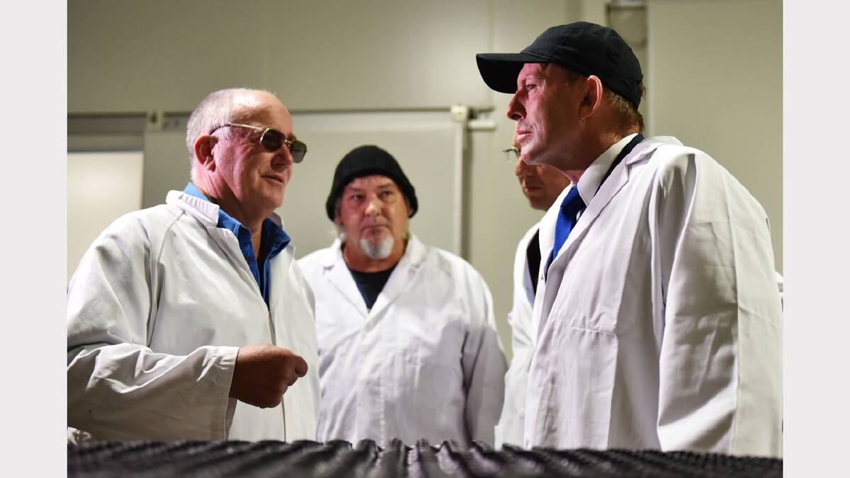 Tasmanian Quality Meats site manager Chris Cocker and skin shed supervisor Dare Code with Prime Minister Tony Abbott at the factory near Cressy. Picture: Scott Gelston
