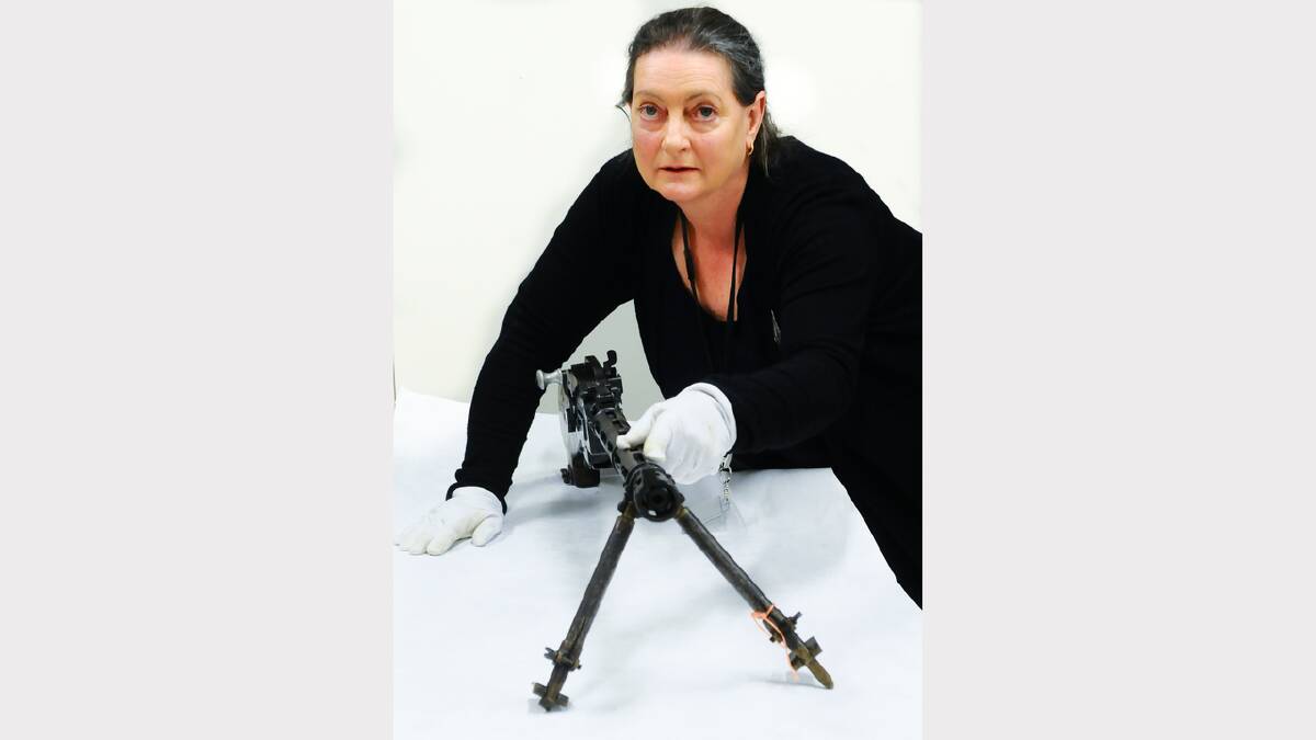 Curator Louise James with a WWI German machine gun, an item that will be included in an upcoming exhibition at QVMAG. Picture: Neil Richardson