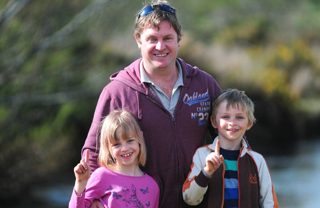 Corey Dolbey, of Prospect, with twins Hermione and Jasper, 7, at the annual Cressy Trout Expo on Saturday. Hermione caught the first fish of the day. Picture: PETER SANDERS