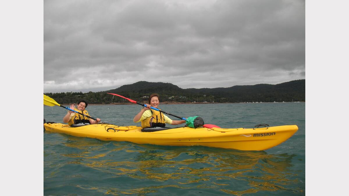 Tourists paddling their way through Coles Bay.