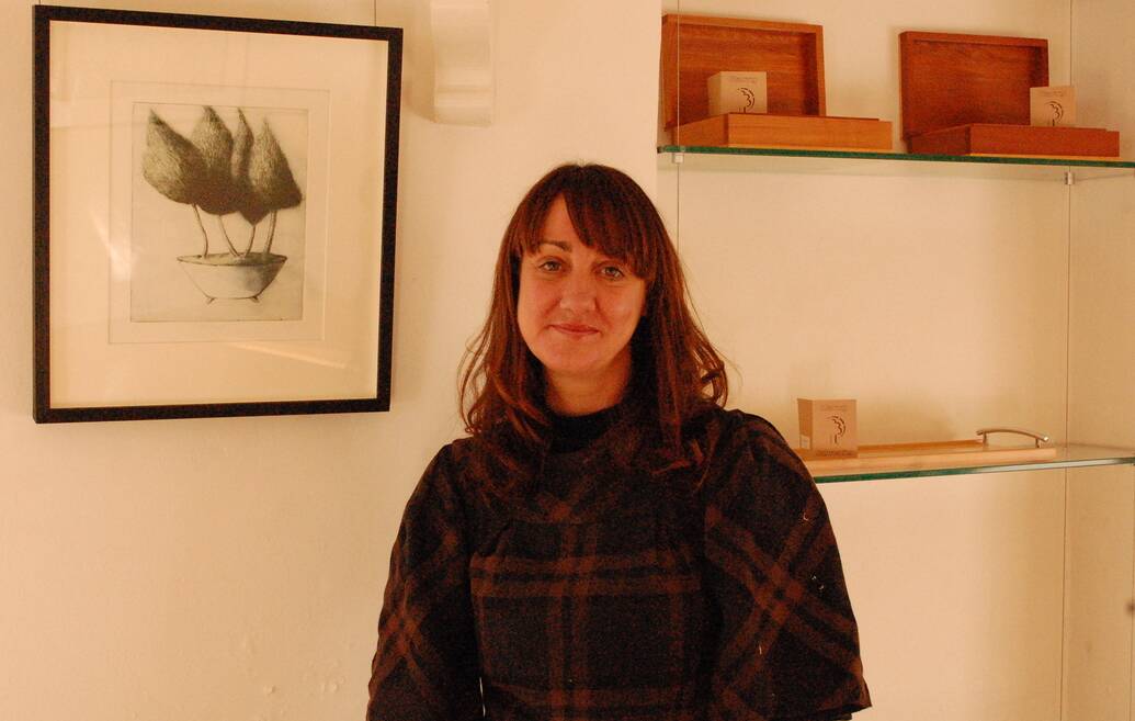 Alice Bradbury stands next to one of the pieces in the Works on Paper exhibition.