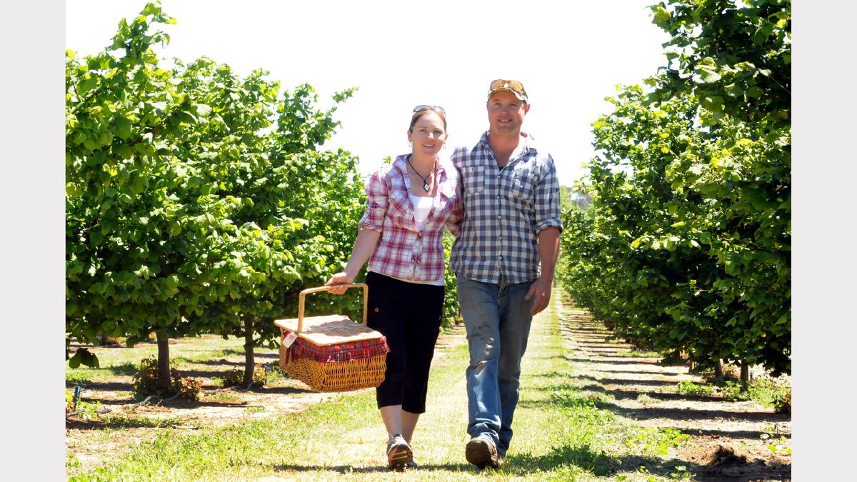 Hazelbrae owners Christie Mcleod and Michael Delphin in their hazelnut orchard. Picture: NEIL RICHARDSON