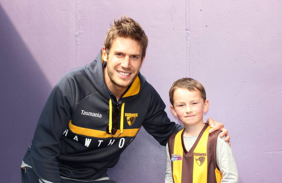 Tasmanian-born Hawk Grant Birchall was reunited with Launceston's William French, who presented Birchall with his premiership medal on Saturday.