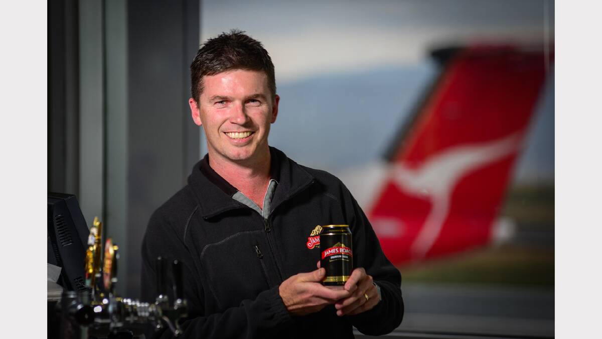 Boag's market activation team member Scott Lister celebrates the Qantas contract with a beer at Launceston Airport yesterday. Picture: Phillip Biggs