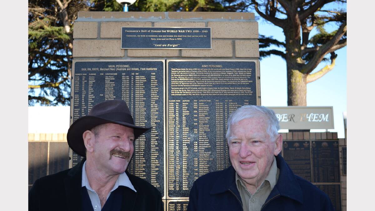Break O'Day mayor Mick Tucker and St Helens and St Marys RSL sub-branch senior vice-president Graham Cameron place the remaining plaque on the World War II Memorial Column.