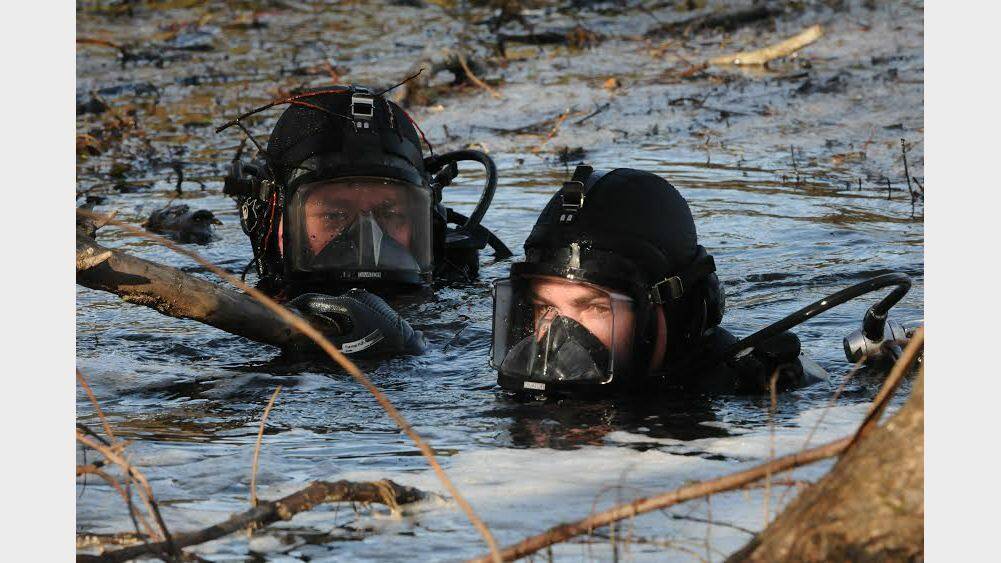 Police divers plunge the depths of the South Esk River. Picture: Neil Richardson
