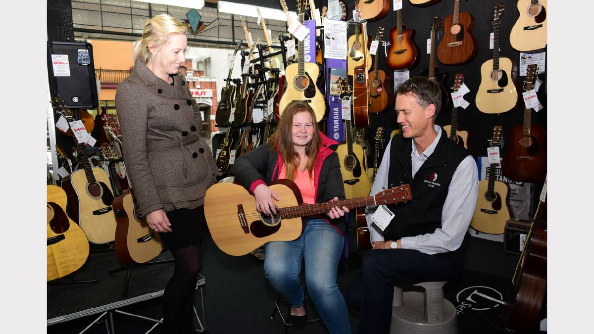 The Examiner's advertising representative Jodie Cooper with Shop and Win winner Olivia Hayes, of Launceston, and Mark Barratt, of Barratts Music. Picture: PAUL SCAMBLER